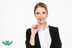 smiling blonde business woman bites pen white wall 250x166 - پنس مژه چیست + کاربرد انواع آن